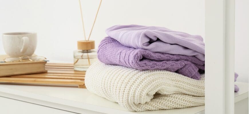 Knitted,Sweaters,On,Shelf,Near,Light,Wall